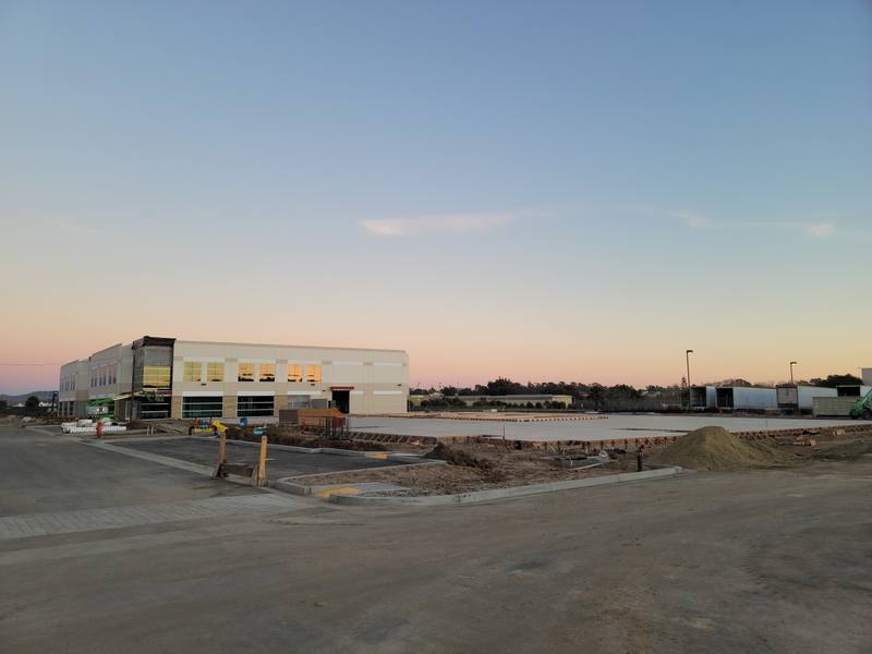 New UCSB building in Goleta at dusk with a graded site in the foreground